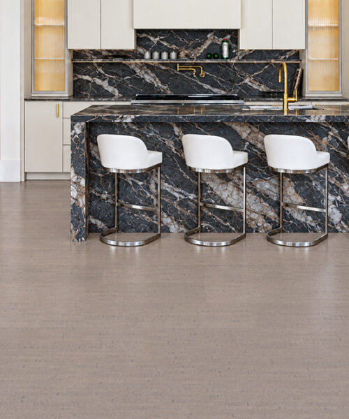 Gray Bamboo - 1/2" (12mm) - Cork Floating (FGB12) Gray Bamboo linear-grain cork flooring anchors a white kitchen with dramatic black marble waterfall island.