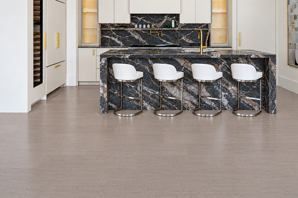 Gray Bamboo - 1/2" (12mm) - Cork Floating (FGB12) Gray Bamboo linear-grain cork flooring anchors a white kitchen with dramatic black marble waterfall island.