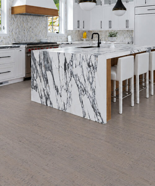 1. Gray Bamboo warm gray cork floor planks surround a marble kitchen island with four counter stools.