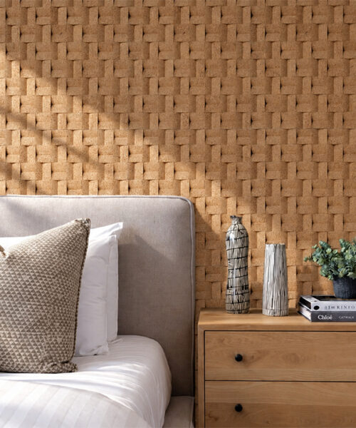 Modern bedroom featuring natural cork accent wall behind upholstered bed with soft sunlight