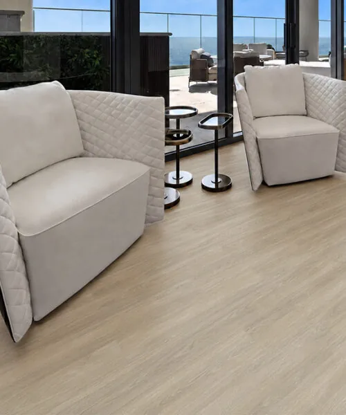 Hamilton - 7/16" (11mm) - Swiss Design Cork Floating (FHam11) Hamilton light beige wood-look cork flooring in a contemporary living room with white lounge chairs