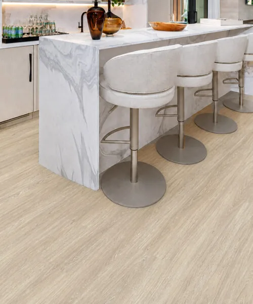 Hamilton - 7/16" (11mm) - Swiss Design Cork Floating (FHam11) Hamilton light gray cork floating floor in a modern kitchen with a marble island and bar stools