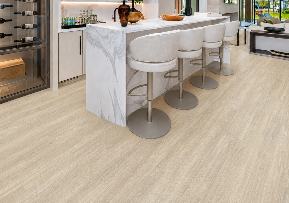 Hamilton - 7/16" (11mm) - Swiss Design Cork Floating (FHam11) Hamilton light gray cork floating floor in a modern kitchen with a marble island and bar stools