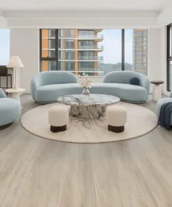 Modern living room featuring Hamilton Swiss Cork floating flooring with light natural wood tones, paired with soft blue contemporary furniture and large windows showcasing a bright open space.