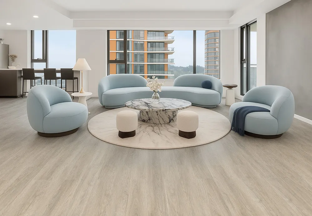 Modern living room featuring Hamilton Swiss Cork floating flooring with light natural wood tones, paired with soft blue contemporary furniture and large windows showcasing a bright open space.