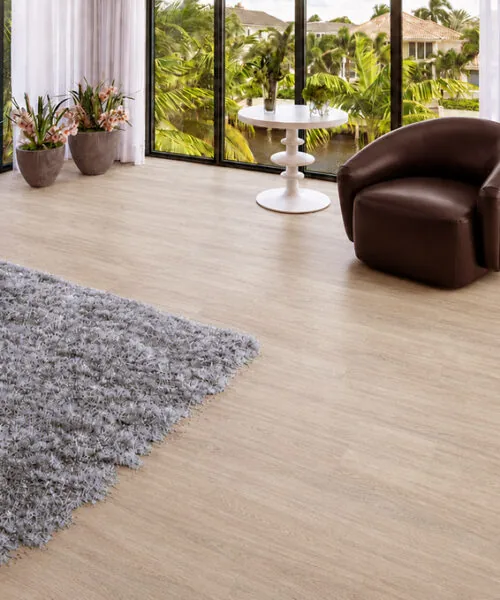 Hamilton - 7/16" (11mm) - Swiss Design Cork Floating (FHam11) Hamilton warm gray wood-grain cork flooring in a sunlit sitting room with floor-to-ceiling windows