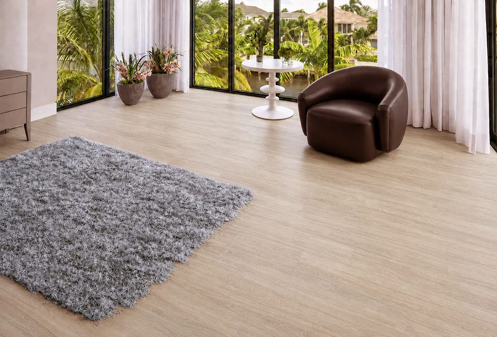 Hamilton - 7/16" (11mm) - Swiss Design Cork Floating (FHam11) Hamilton warm gray wood-grain cork flooring in a sunlit sitting room with floor-to-ceiling windows