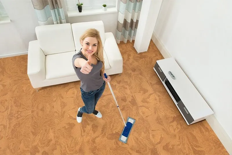 high angle view young woman mopping cork floor caramel swirl forna