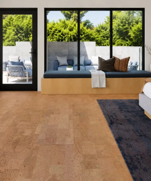 Leather - 1/2" (12mm) - Cork Floating (FLe12) Modern bedroom featuring Leather Natural 12mm cork floating flooring with a cozy window seat, large black-framed windows, and warm natural cork texture.
