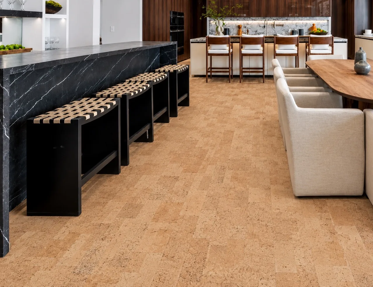 Leather - 1/2" (12mm) - Cork Floating (FLe12) Luxury kitchen featuring Leather Natural cork floating flooring, a dramatic black marble island, and warm wood cabinetry with bar stools.