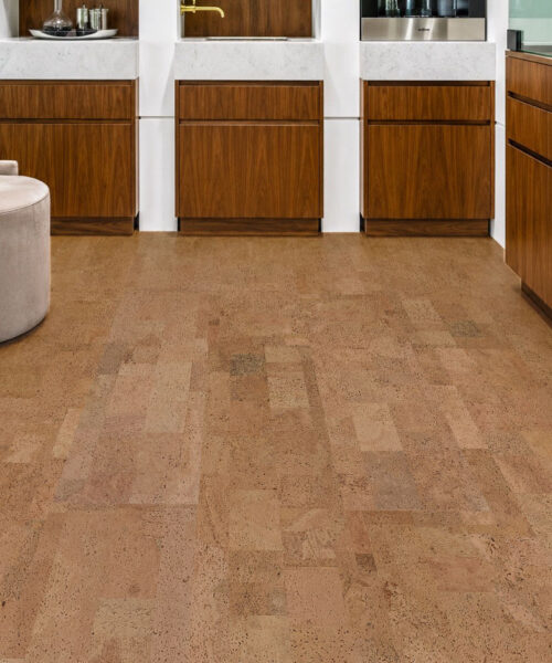 Elegant walnut kitchen showcasing Leather Natural cork flooring, marble countertops, and premium wood cabinetry.