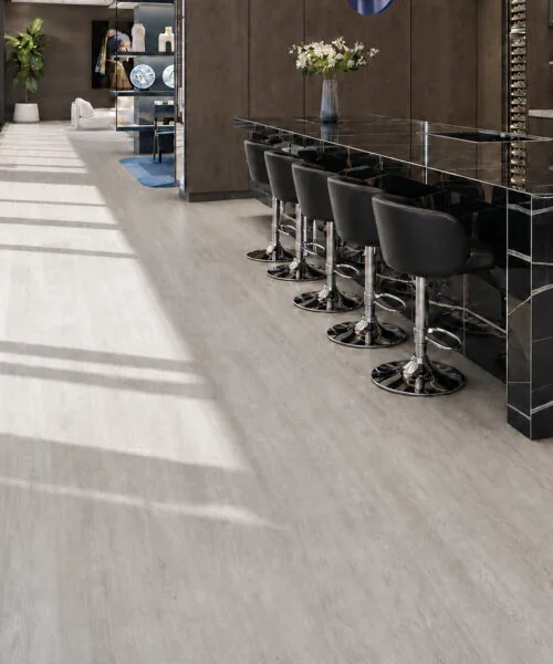 Light Grey Oak - 13/32" (10.5mm) - Design Cork Floating (FLG10.5) Sunlit luxury kitchen with light grey oak floating cork floor and marble breakfast bar