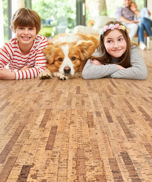 Linea Dark - 7/16" (11mm) - Swiss Real Cork Floating (FLin11) Children and pet relaxing on Linea Dark Swiss cork flooring, highlighting its warmth, softness, and family-friendly performance.