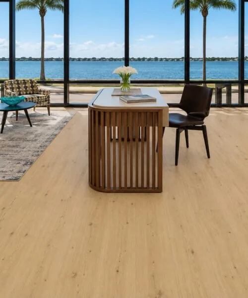 Natural light oak Long Beach Swiss Design cork flooring enhances a contemporary sitting area with designer chairs, dining space, and expansive glass doors.