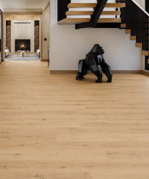 Long Beach - 7/16" (11mm) - Swiss Design Floating (FLB11) Light oak Long Beach Swiss Design cork floating flooring installed in a modern entryway with floating staircase, black steel accents, and open-concept luxury interior.