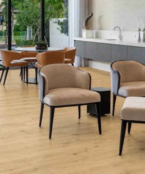 Wide-plank Long Beach Swiss Design cork flooring in a luxury waterfront office with floor-to-ceiling windows, designer desk, and natural daylight.