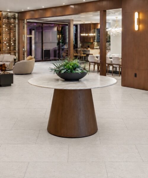Matera Blend -19/64" (7.5mm) - Swiss Techslate (MMatBd7.5) Matera Blend Swiss TechSlate flooring in light limestone shows subtle mineral speckling and 18-by-36-inch planks in a furnished living-dining room.