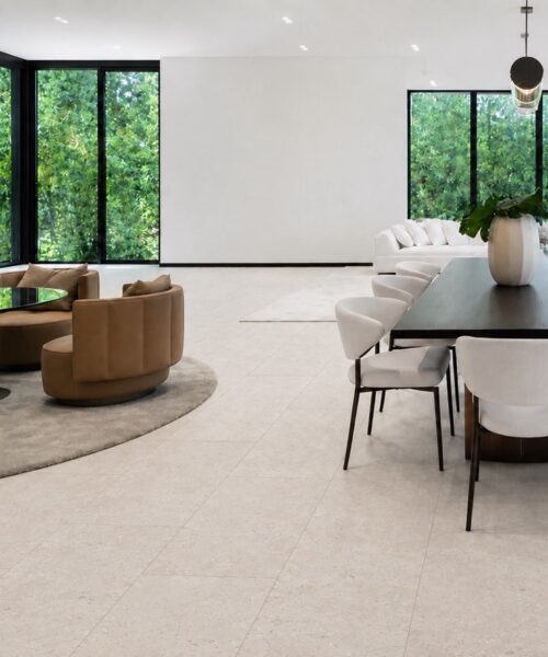 Matera Blend -19/64" (7.5mm) - Swiss Techslate (MMatBd7.5) Matera Blend Swiss TechSlate flooring shows light limestone mineral speckling across a dining room with a long table and lounge chairs.