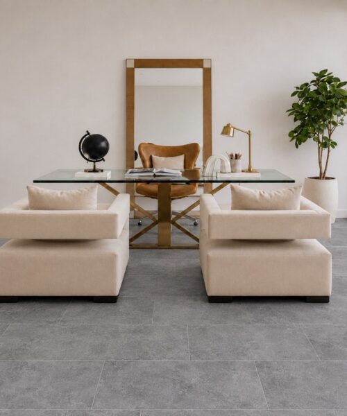 Midnight Slate TechSlate flooring brings a gray stone-look mineral pattern to a bright home office with a glass desk and lounge chairs.