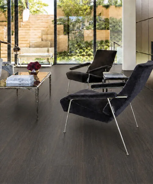 Mocha - 7/16" (11mm) - Swiss Design Cork Floating (FMoc11) Elegant living room with dark Mocha cork floors, a modern fireplace, and floor-to-ceiling windows.