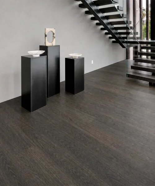 Mocha - 7/16" (11mm) - Swiss Design Cork Floating (FMoc11) Bright traditional foyer with dark Mocha cork plank flooring, white walls, and black staircase accents.