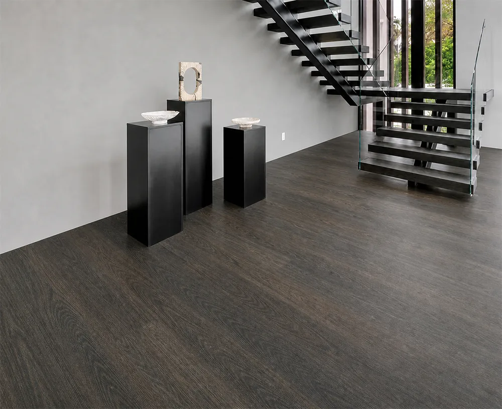 Mocha - 7/16" (11mm) - Swiss Design Cork Floating (FMoc11) Bright traditional foyer with dark Mocha cork plank flooring, white walls, and black staircase accents.