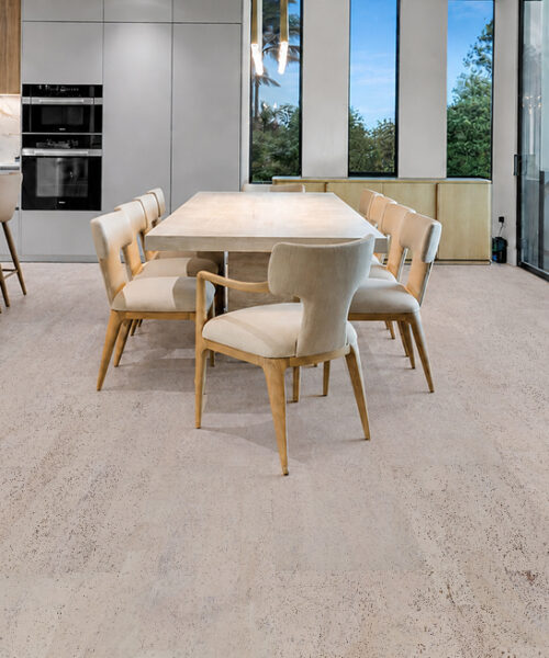 Mystic Vanilla Swiss Real Cork Floating Flooring features pale textured planks beneath a contemporary kitchen and dining area.