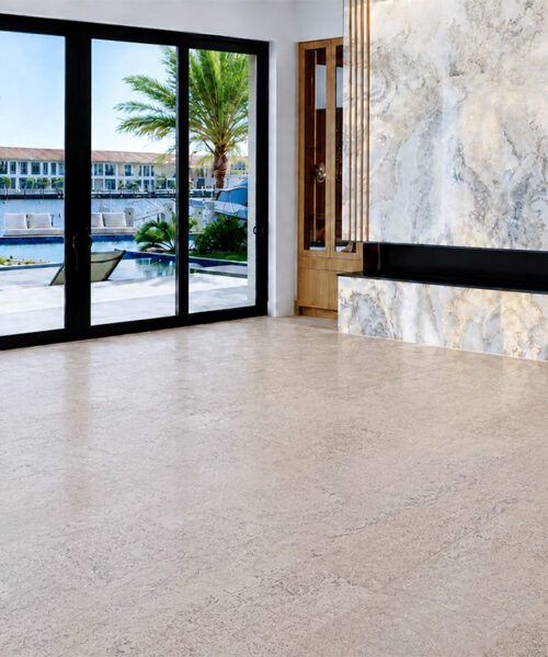 Light Mystic Vanilla Swiss Real Cork Floating Flooring extends through a waterfront foyer with marble walls and glass doors.