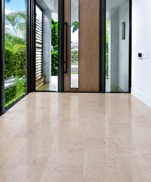 Pale Mystic Vanilla cork floor planks create a seamless layout across a sunlit modern entrance hall.