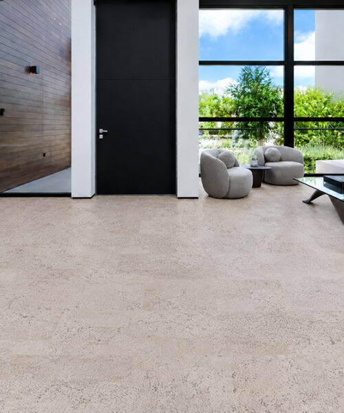 Mystic Vanilla sustainable flooring shows subtle cork texture throughout a contemporary living room with neutral furniture.