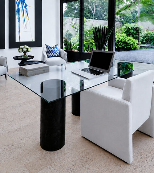 Mystic Vanilla cork flooring for an office features pale textured planks beneath a glass desk and white chairs.