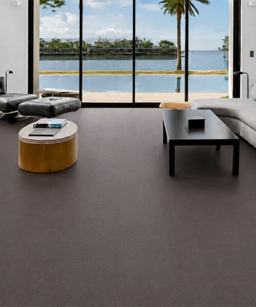 Night - 7/16" (11mm) - Swiss Real Cork Floating (FNig11) Night comfortable cork flooring covers a waterfront living room with curved sofas and floor-to-ceiling windows.