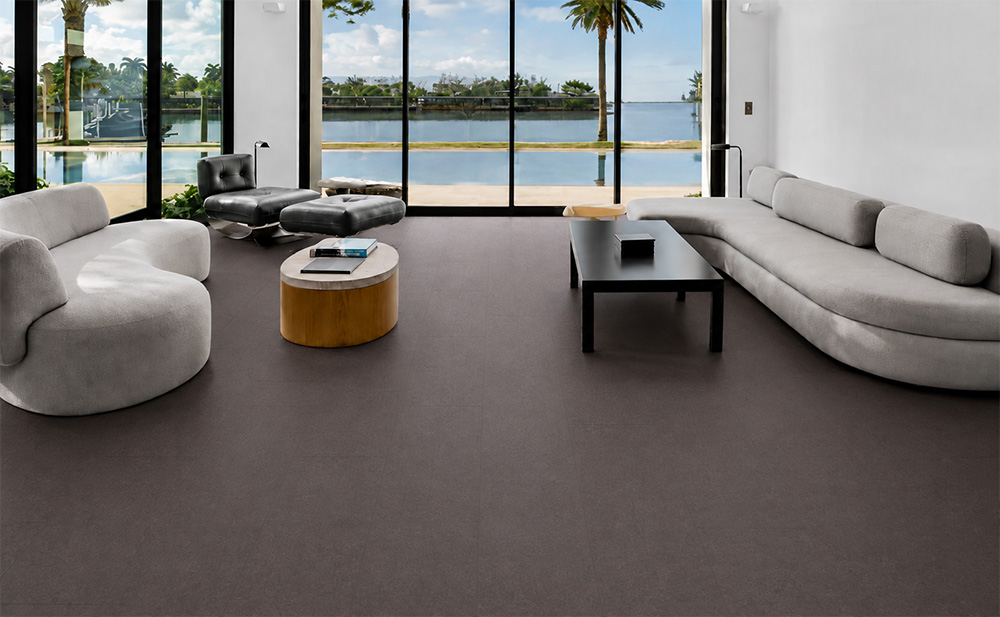 Night - 7/16" (11mm) - Swiss Real Cork Floating (FNig11) Night comfortable cork flooring covers a waterfront living room with curved sofas and floor-to-ceiling windows.