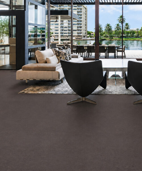 Night - 7/16" (11mm) - Swiss Real Cork Floating (FNig11) Night eco-friendly cork flooring extends across a waterfront lounge with modern seating and expansive glass walls.