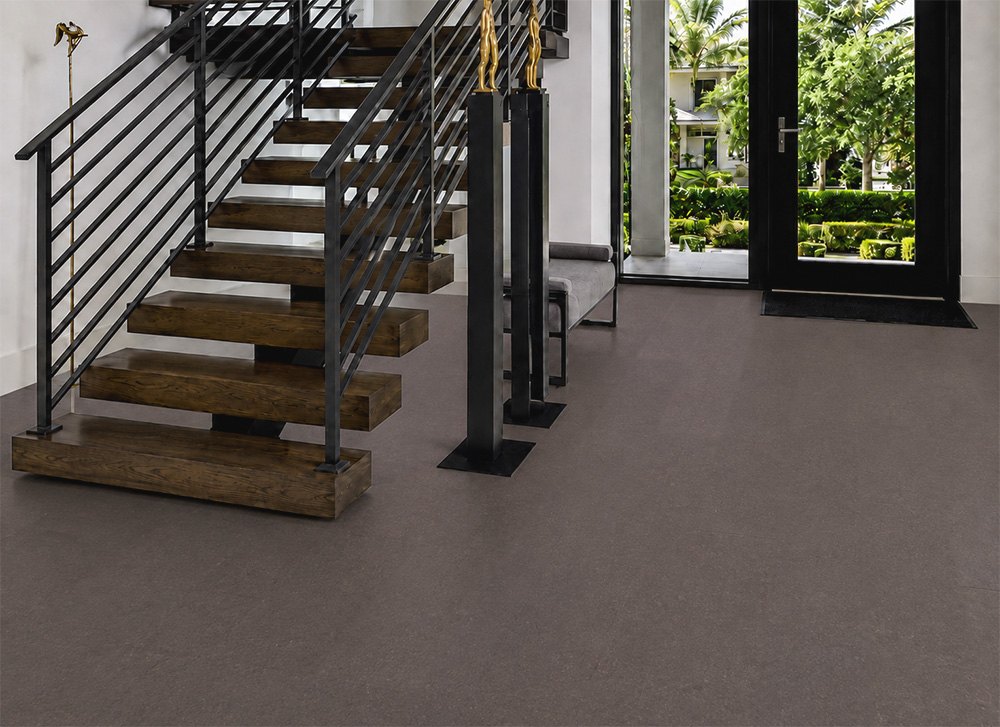 Night - 7/16" (11mm) - Swiss Real Cork Floating (FNig11) Night Swiss cork floor planks continue through a modern foyer with wooden stairs and glass doors.