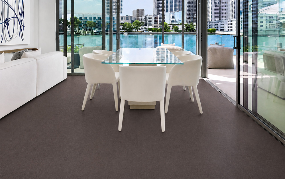 Night - 7/16" (11mm) - Swiss Real Cork Floating (FNig11) Night dark cork floor planks complement a white dining set overlooking a bright urban waterfront.