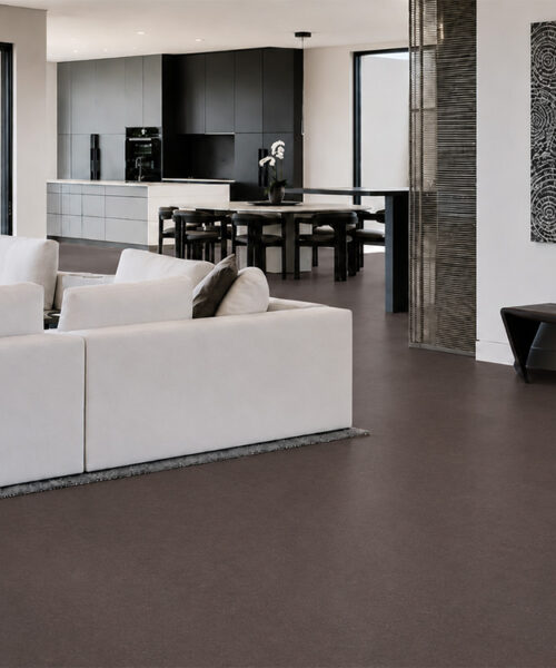 Night - 7/16" (11mm) - Swiss Real Cork Floating (FNig11) Night natural cork flooring connects a contemporary living room, dining area, and kitchen in an open layout.