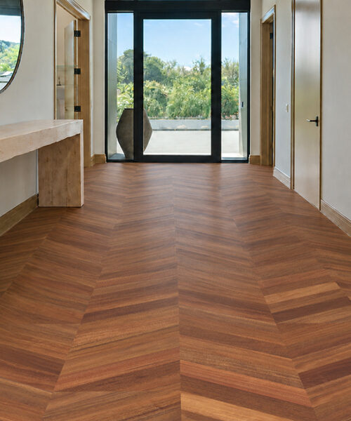 Rich walnut Noble Chevron cork flooring creates a French parquet look in a contemporary entrance hallway.