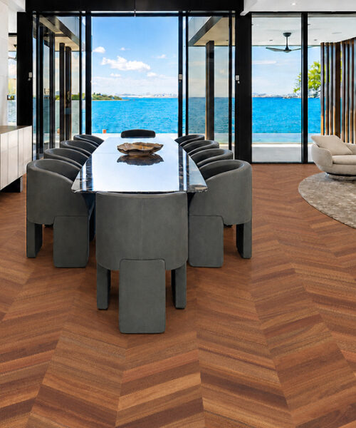 Noble Chevron Swiss Design Cork Flooring complements a coastal dining room with dark chairs and ocean views.