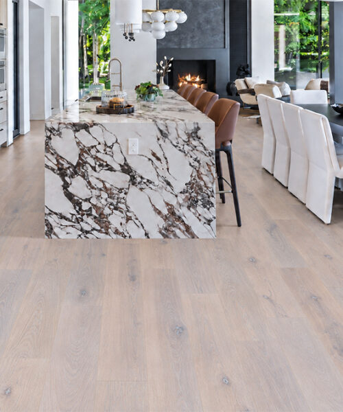 Nordic Oak Natural Composite Flooring with cork backing and Scandinavian grain spans an open kitchen, dining space, and fireplace seating.