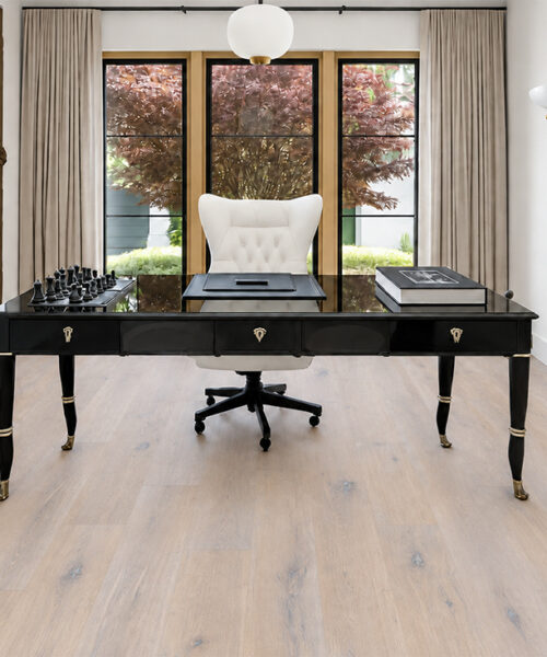 White-gray Nordic Oak commercial-grade Natural Composite Flooring complements a black executive desk, chess set, and sculpted feature wall.