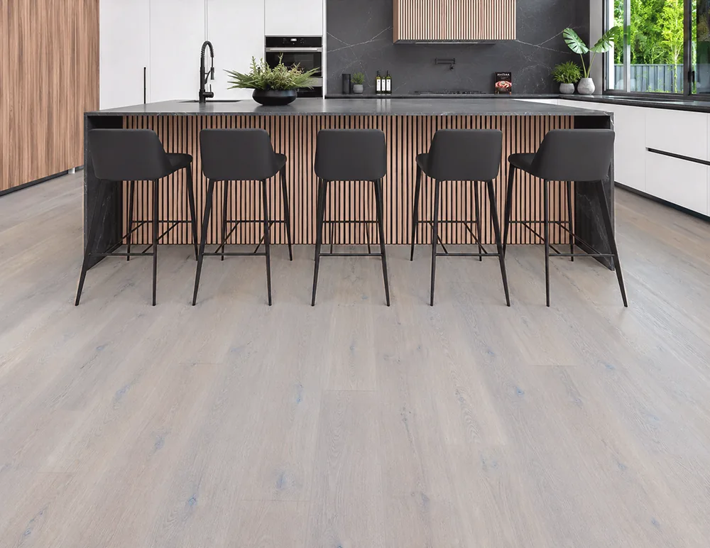 Nordic Oak - 3/8" (9.5mm) - Forna Natural Composite Flooring with Waterproof Hydrowood Core (NNorO9.5) Pale oak look floating flooring in a modern kitchen with marble countertops and white bar stools