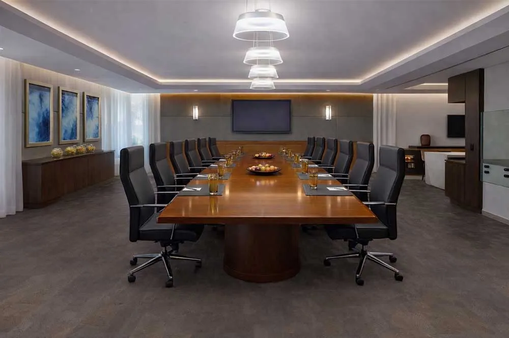 Luxury corporate boardroom with dark Onxy Swiss cork flooring, modern meeting table and elegant office lighting.