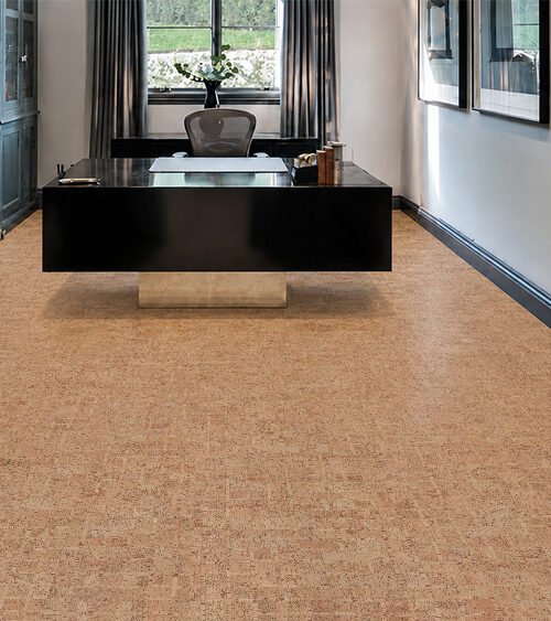 Warm tan ParCork cork flooring for an office surrounds a black desk and dark built-in cabinetry.