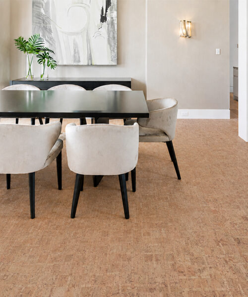 Natural brown ParCork cork floor planks complement a modern dining room with cream upholstered chairs.