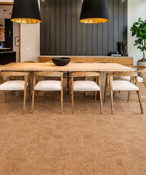 ParCork eco-friendly cork flooring adds warm texture beneath a wood dining table and pendant lights.