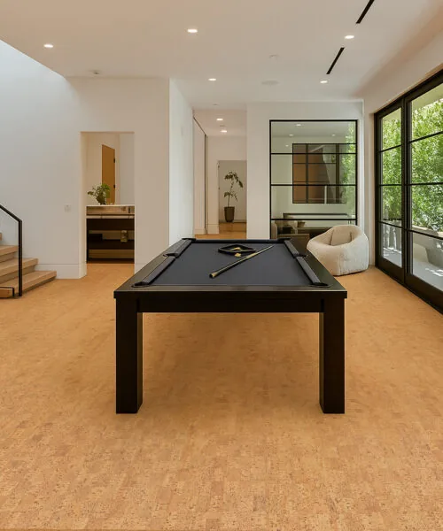 Quadro-B - 7/16” (11mm) - Swiss Real Cork Floating (FQuaB11) Modern recreation room with billiard table and open windows showcasing Quodro Swiss cork flooring’s natural texture and sound-reducing surface.