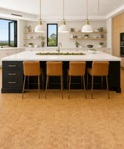 Contemporary kitchen with wood cabinetry and black island accented by Quodro Swiss cork flooring in golden beige, creating a cozy, quiet atmosphere.