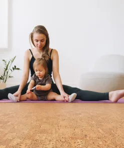Bright yoga room with mother and child on mat, highlighting Quodro Swiss cork flooring’s cushioned, non-toxic surface perfect for family wellness.