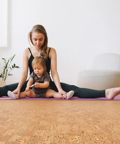 Bright yoga room with mother and child on mat, highlighting Quodro Swiss cork flooring’s cushioned, non-toxic surface perfect for family wellness.